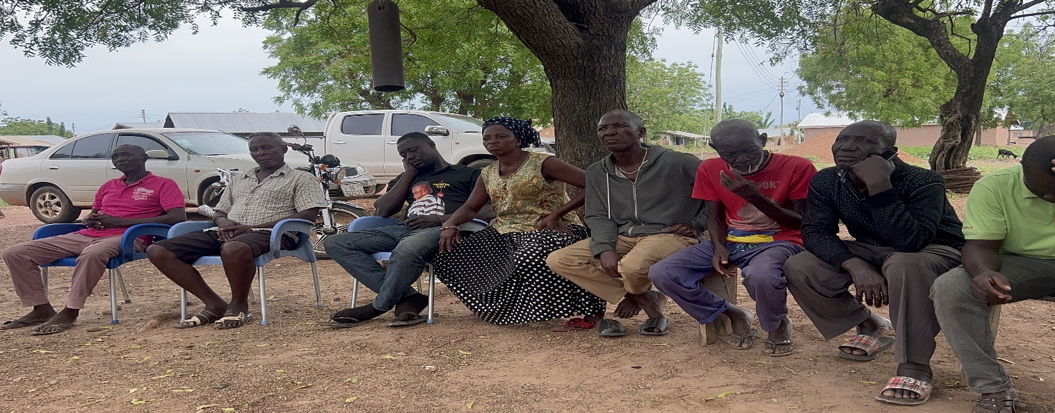 Community meeting under a tree in Bruben