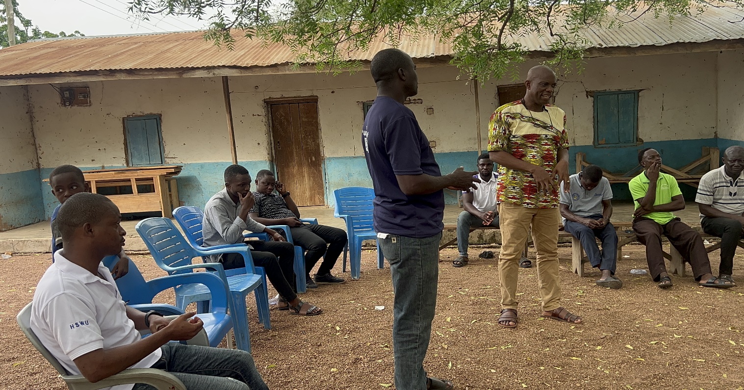 Residents seated during a community durbar in Bruben